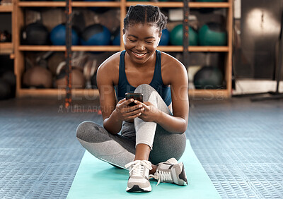 Buy stock photo Happy black woman, fitness and phone for social media, communication or networking at the gym. African female person or athlete typing, texting or chatting on mobile smartphone after workout exercise