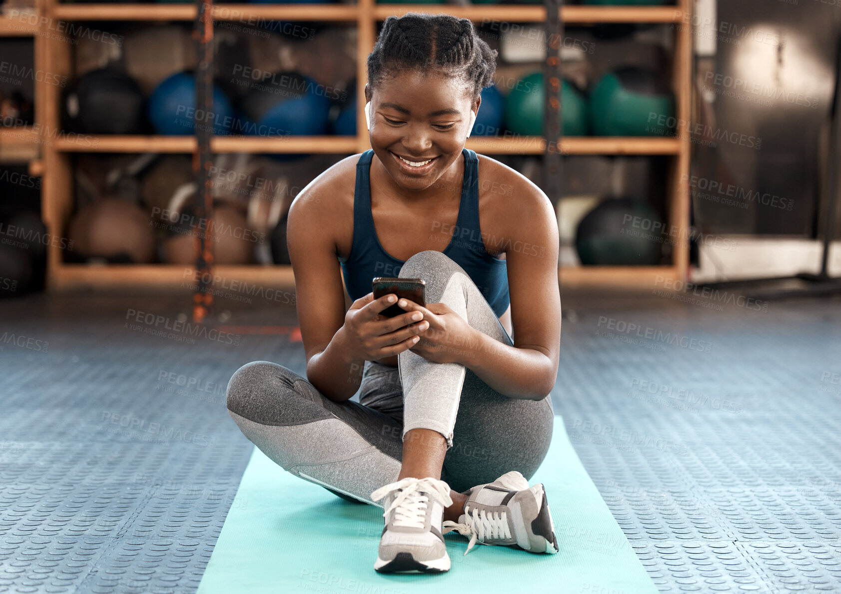 Buy stock photo Happy black woman, fitness and phone for social media, communication or networking at the gym. African female person or athlete typing, texting or chatting on mobile smartphone after workout exercise