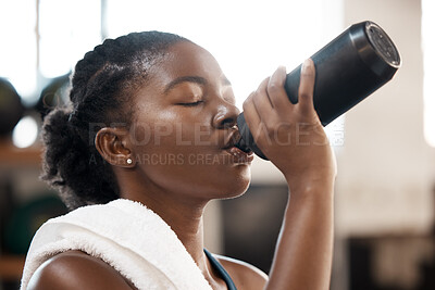Buy stock photo Black woman, fitness and drinking water at gym for sustainability, hydration or thirst after workout exercise. Thirsty African female person with drink for refreshment after cardio training indoors