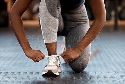 Buy stock photo Woman, hands and tying shoes in fitness at gym or running, exercise or cardio workout indoors. Hand of female person, athlete or runner tie shoe in preparation for exercising or training run on floor