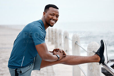 Buy stock photo Stretching, fitness and portrait of black man by ocean for exercise, marathon training and running. Sports, nature and happy male person stretch legs for warm up, cardio workout and wellness by sea