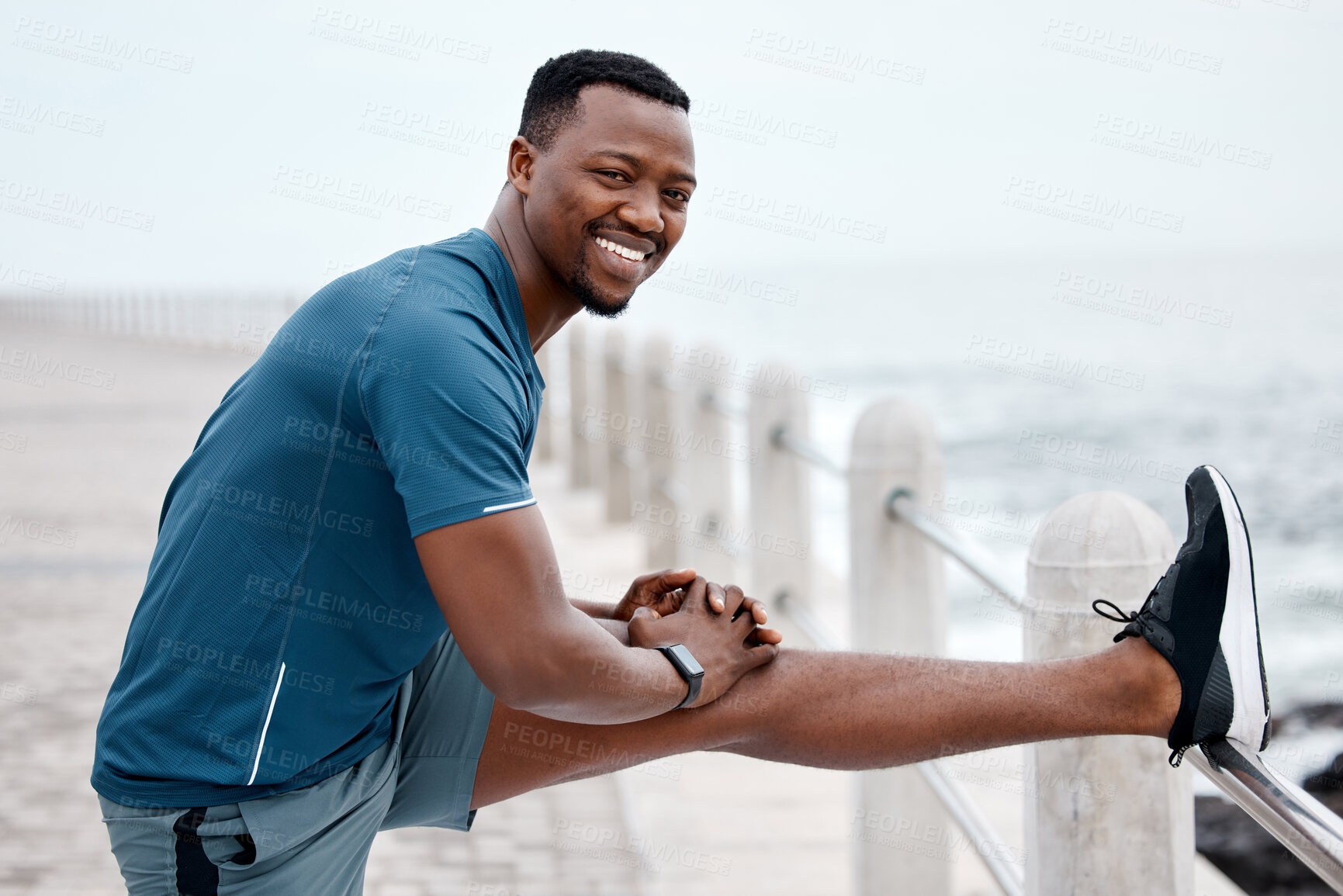 Buy stock photo Stretching, fitness and portrait of black man by ocean for exercise, marathon training and running. Sports, nature and happy male person stretch legs for warm up, cardio workout and wellness by sea