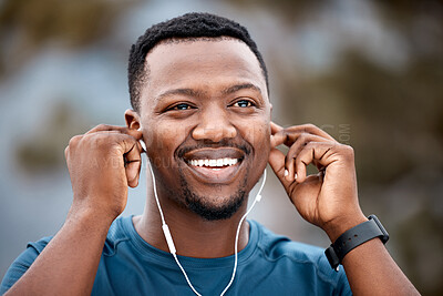 Buy stock photo Black man, earphones and listening to music with smile in workout, exercise or cardio training in nature. Happy African male person, athlete or runner smiling for audio sound track or outdoor fitness