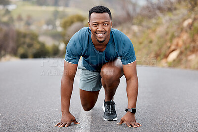Buy stock photo Portrait of a sporty young man crouching at starting position while exercising outdoors