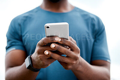 Buy stock photo Closeup shot of an unrecognisable man using a cellphone while exercising outdoors