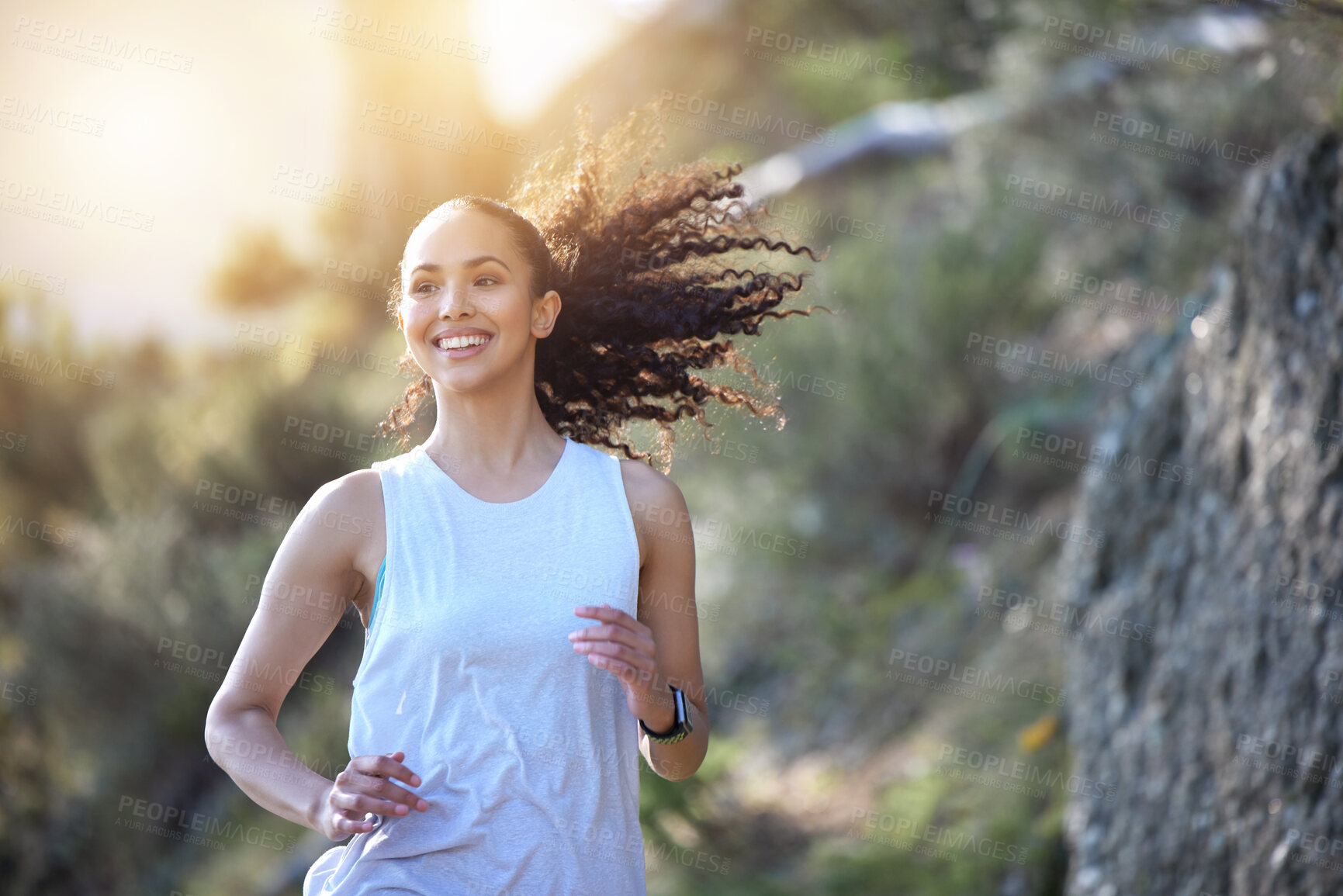 Buy stock photo Happy woman, running and smile in forest for fitness, workout or cardio exercise in the outdoors. Fit, active or sporty female person or runner smiling for healthy wellness, run or training in nature