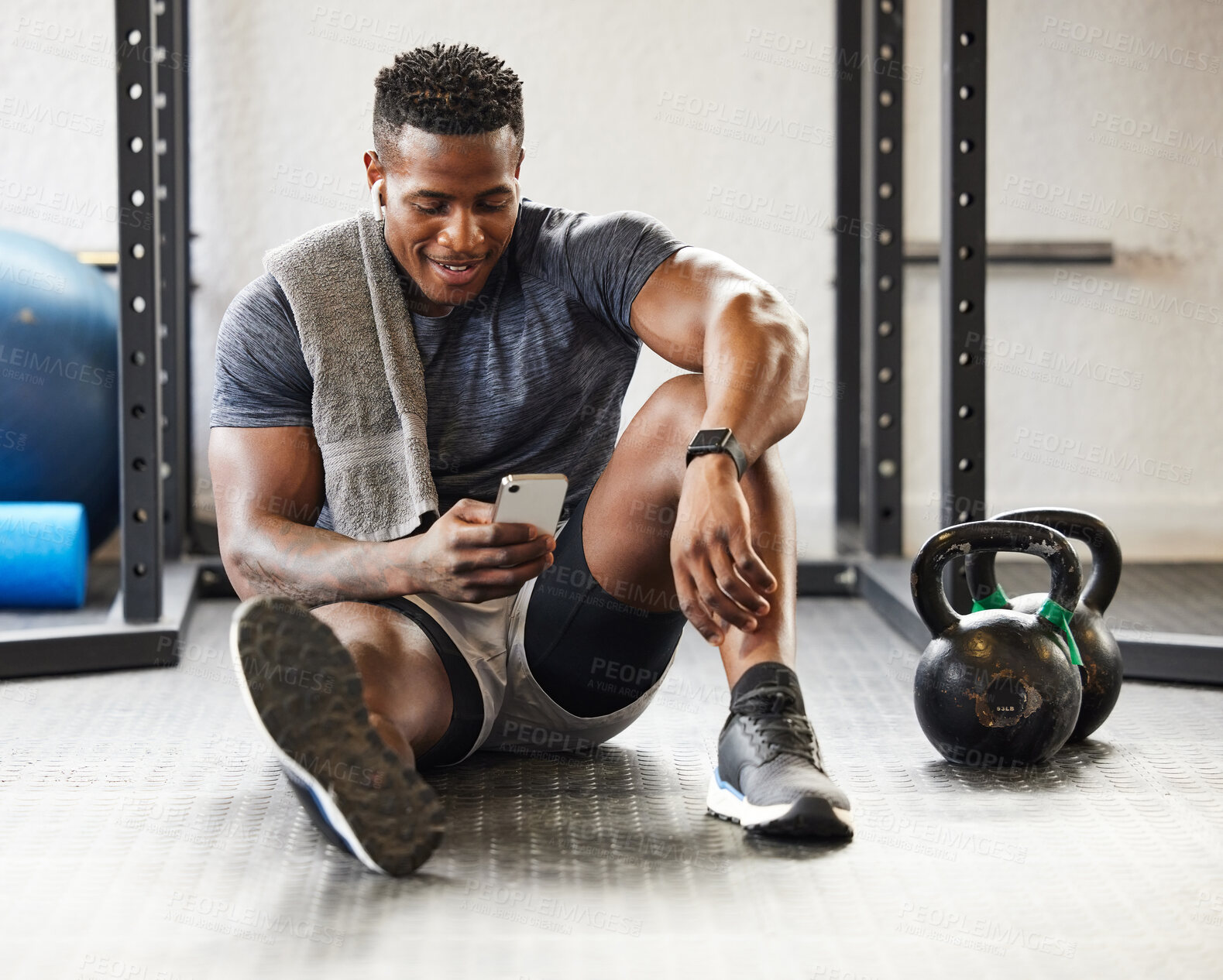 Buy stock photo Fitness, phone and black man typing in gym on break after exercise, training or workout. Athlete, smartphone and happy African male person on sports app, networking or social media, email and relax.