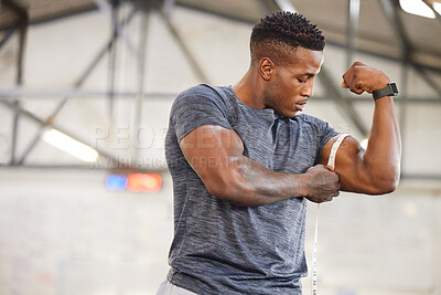 Buy stock photo Black man, tape measure and bicep with muscle and strong athlete, weightlifting and fitness in gym. Power, challenge and arm measurement, male person with exercise and bodybuilding with mockup space