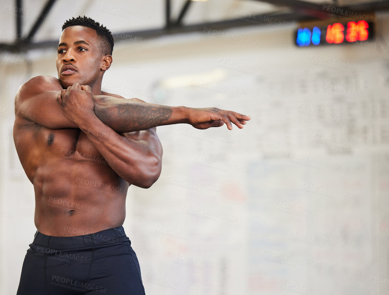 Buy stock photo Shirtless black man, stretching arms and fitness in gym with muscle, strong and abs with workout and mockup space. Focus, serious male athlete and bodybuilder, warm up and ready for exercise