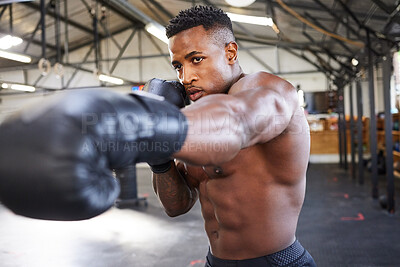 Buy stock photo African man, boxing and punching in gym for fitness, focus or training for growth, goal and health for competition. African guy, boxer and gloves for exercise, wellness or martial arts club for sport