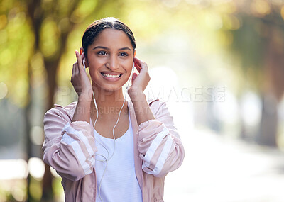Buy stock photo Girl, park and outdoor with sportswear, earphones and fitness in nature, smile and exercise in woods. Wellness, city and runner with happiness, listening and audio in radio, healthy and bokeh of road