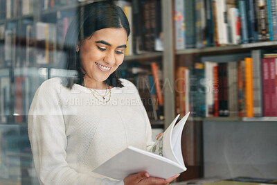 Buy stock photo Woman, student and reading in college library with smile for research, learning and education. Happy, female person, and university bookshelf with novel, literature or biography for studying