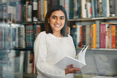 Buy stock photo Woman, student and portrait reading in college library with smile for research, learning and education. Happy, female person, and university bookshelf with novel, literature or biography for studying