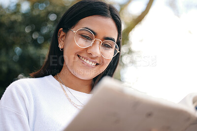 Buy stock photo Girl, student or reading with book in garden for university, studying or research on campus. Female person, learning or notebook with glasses in park for future, education or knowledge for college