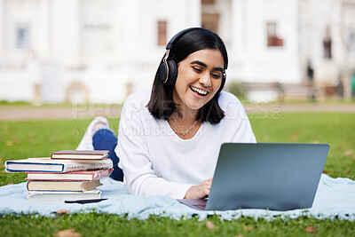 Buy stock photo Relax, grass and girl with laptop, headphones and books on campus for research, online project or report. Education, computer and college student in park with blanket, streaming music and studying