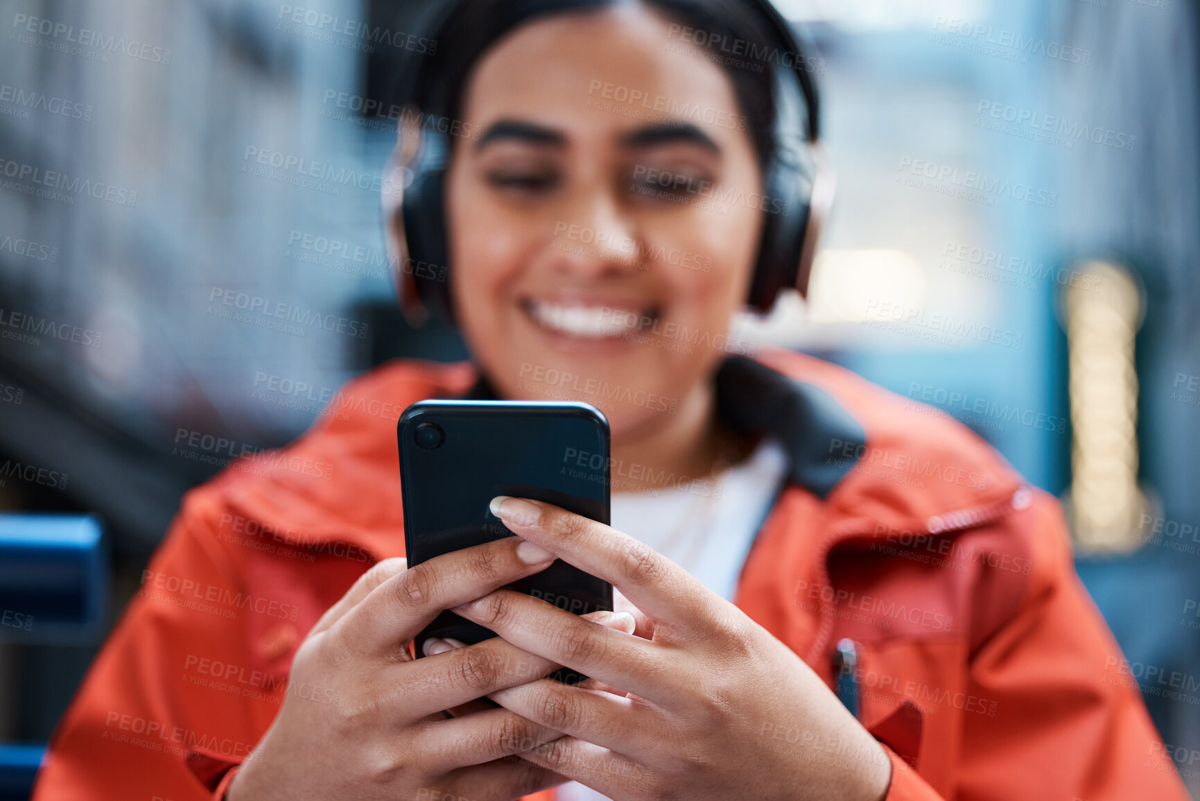 Buy stock photo Woman, hands and smile with headphones for smartphone with texting or streaming for entertainment. Music, movie or educational video with fun in college or home with study, higher education and happy