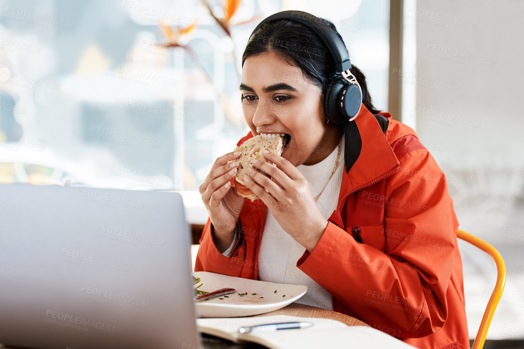 Buy stock photo Woman, student and happy on laptop with burger for streaming platform, podcast and entertainment on study break. Female person, university learner and smile for music playlist and videos at cafe