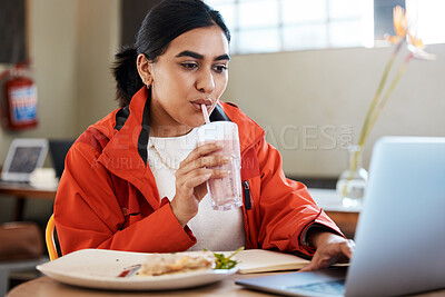 Buy stock photo Shot of a young female student using a laptop while studying at college