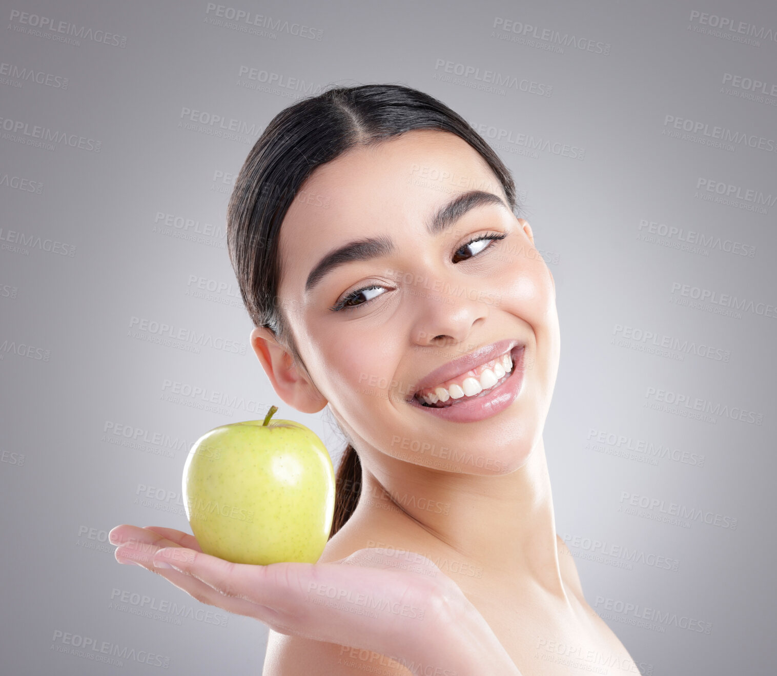 Buy stock photo Apple, beauty and face of natural woman in studio on gray background for diet, fruit or nutrition. Food, health or skincare and happy model with fresh produce for organic dermatology or detox