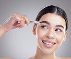 Shaping her eyebrows