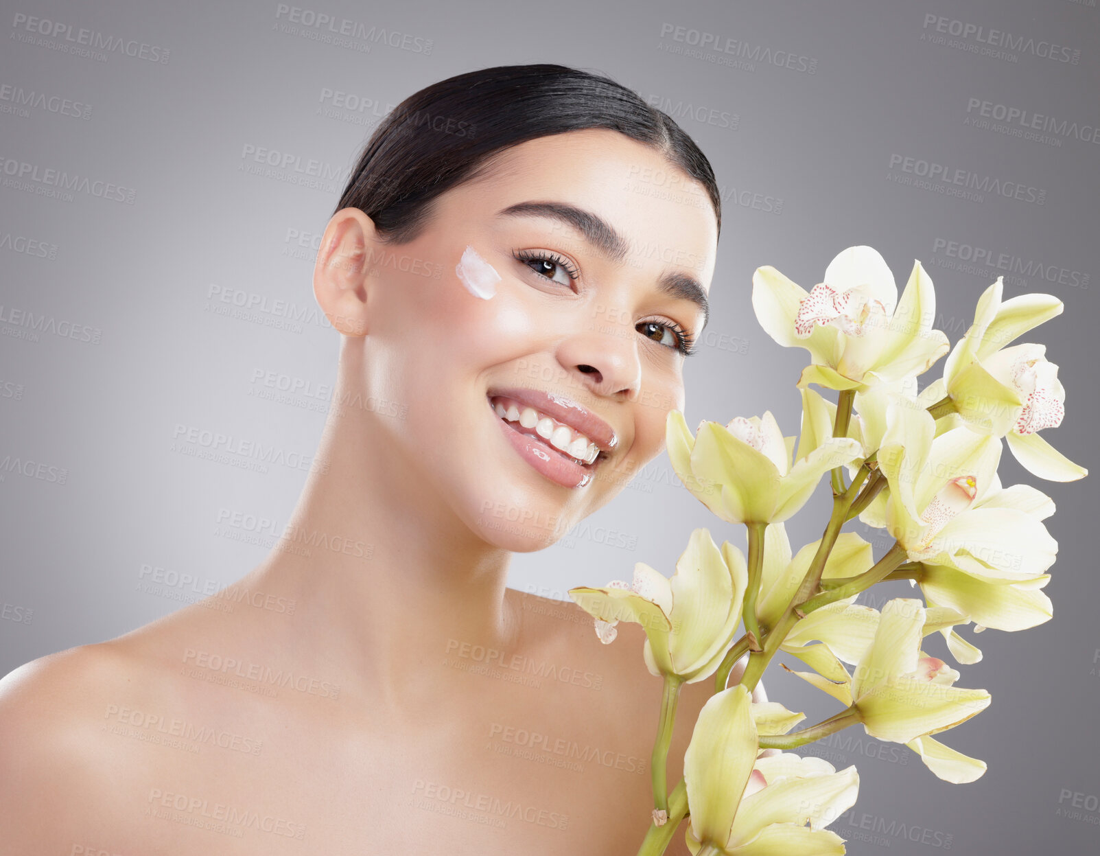 Buy stock photo Woman, portrait and plants for cream in studio, sunscreen and eco friendly skincare on gray background. Female person, beauty and moisturizer for hydration, orchids and lotion treatment for cosmetics