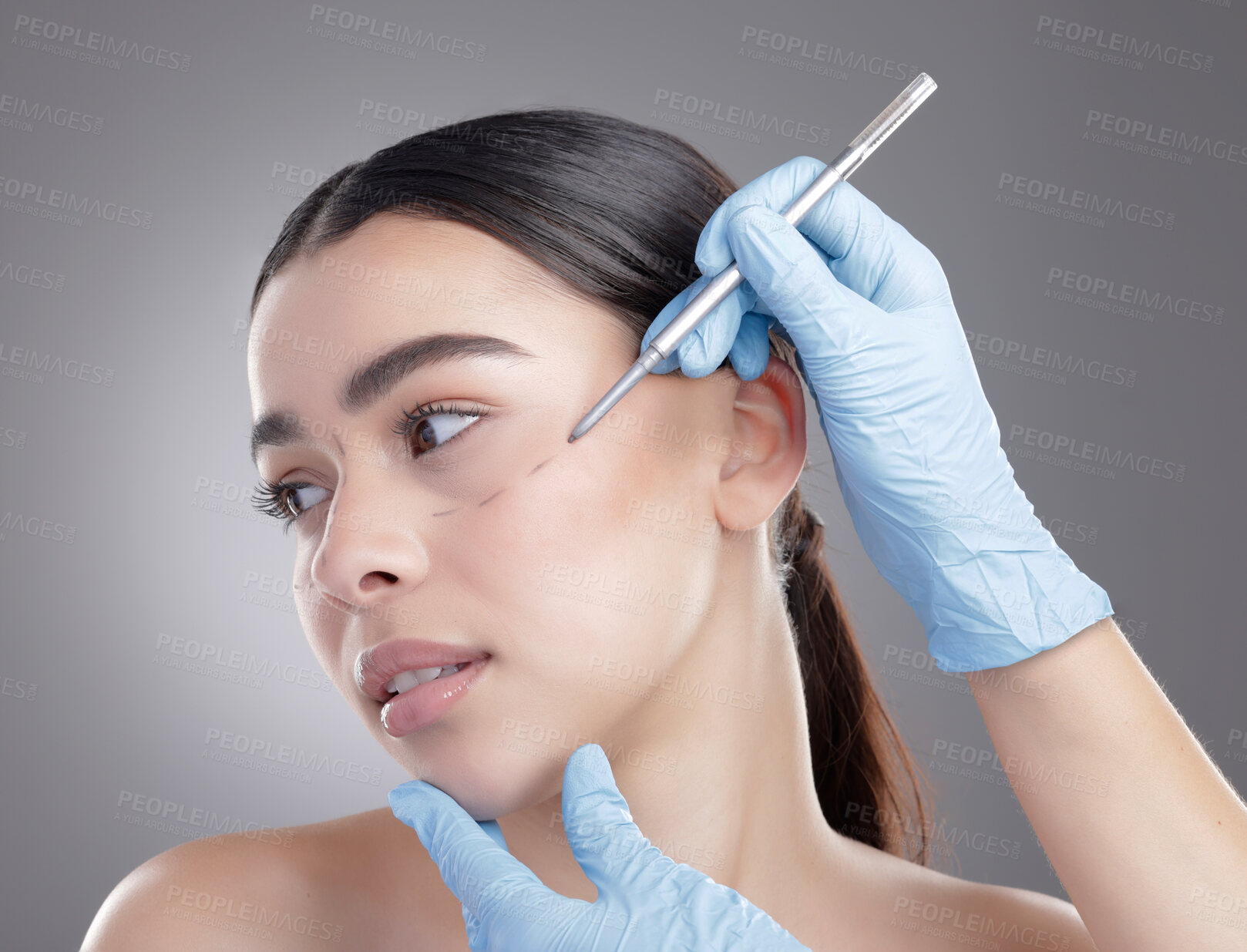 Buy stock photo Hand, plastic surgery and face of woman and studio for skincare, wellness and healthcare and marking. Grey background, consultation and person with ink safe for skin, girl and clinic for aesthetic