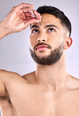 Buy stock photo Face, self care and tweezers with a man model plucking eyebrows in studio background, hair removal or trim. Skincare, wellness and beauty routine for grooming, hygiene and cosmetics for cleaning skin