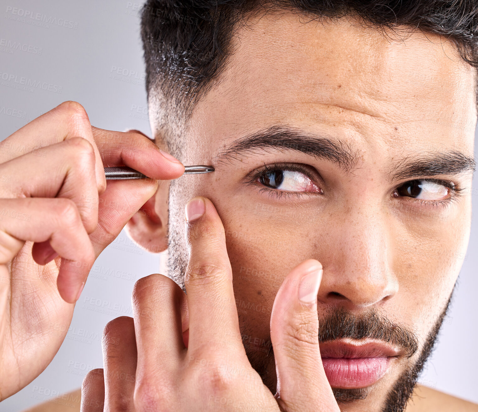 Buy stock photo Man, trim eyebrow and skincare on face in studio, selfcare and personal grooming. Model, hygiene and person with tweezers for hair removal or routine, cleaning and treatment in grey background