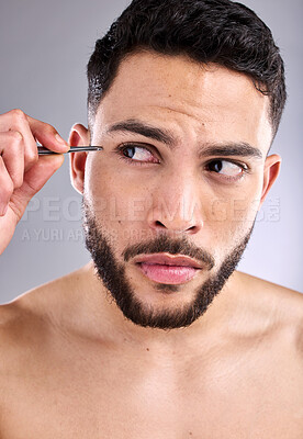 Buy stock photo Man, cleaning and tweezers for eyebrow on face in studio, selfcare and personal grooming. Model, hygiene and person plucking for hair removal or skincare, cosmetic and treatment in grey background