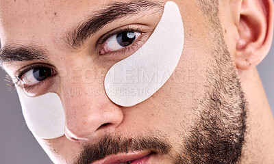 Buy stock photo Beauty, portrait and eye mask with man in studio on gray background for antiaging, facial or skincare. Aesthetic, face and wellness with serious model for dermatology, grooming or natural hydration