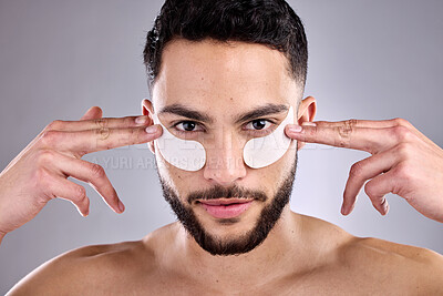 Buy stock photo Beauty, eye mask and portrait of man in studio for antiaging skincare treatment or wellness. Aesthetic, dermatology or face of confident model and patch on skin for change, collagen or transformation