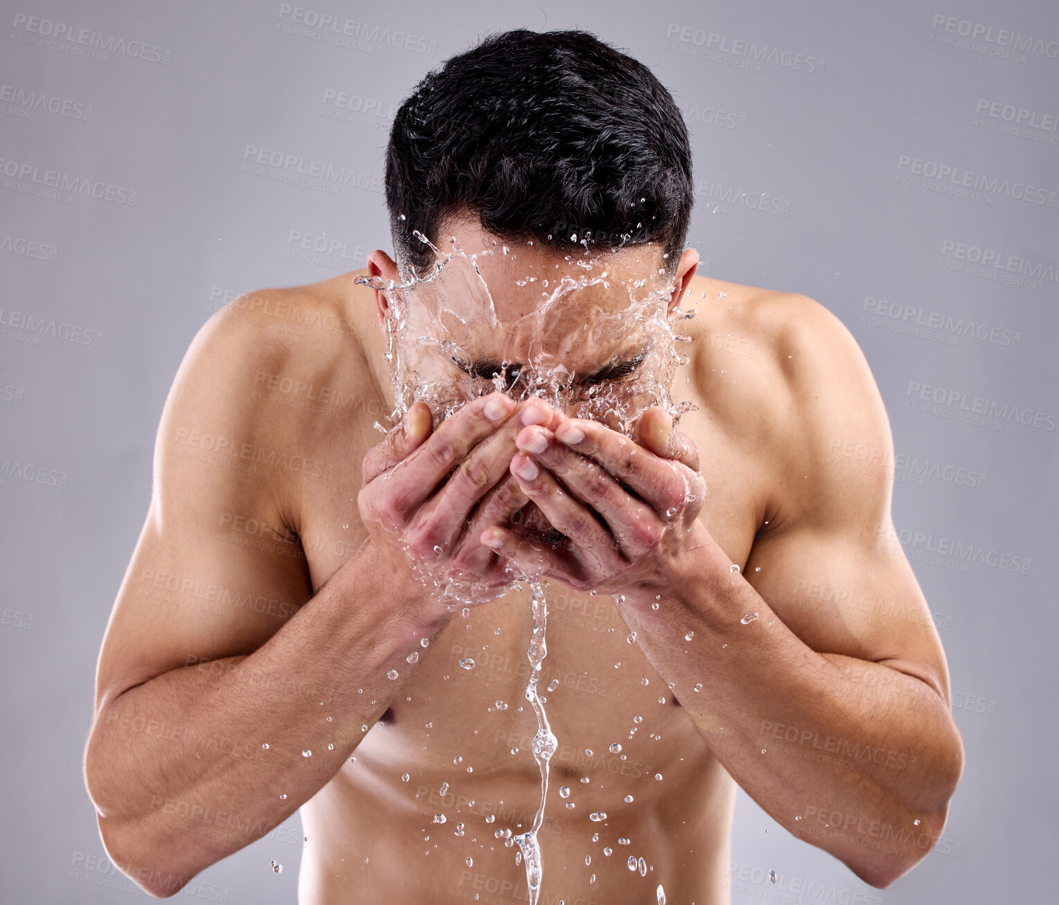 Buy stock photo Man, splash and water for cosmetic, wellness and skincare with grooming, routine and body care. Male person, face and gray background for health, fitness and dermatology for hygiene, clean and glow