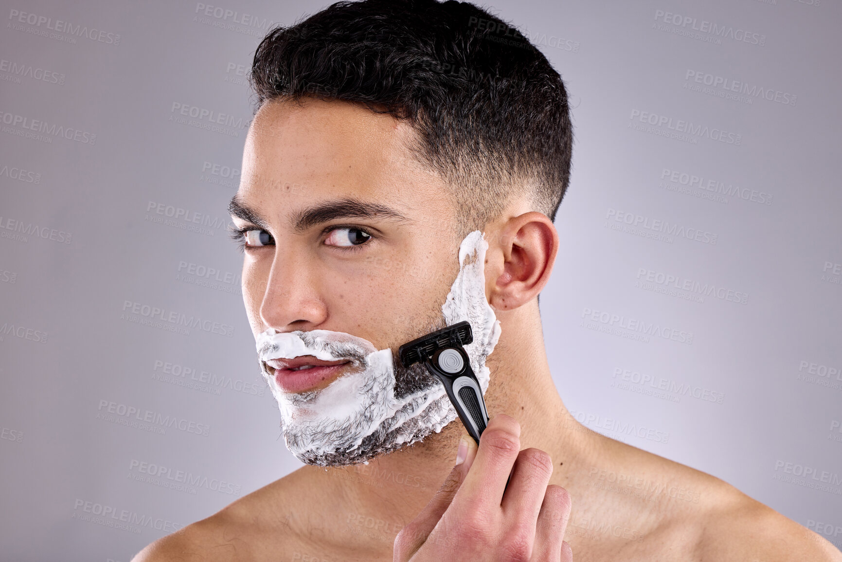 Buy stock photo Beauty, portrait and shaving beard with man in studio on gray background for grooming or skincare. Aesthetic, hair removal and razor with confident model in bathroom for cosmetics or dermatology