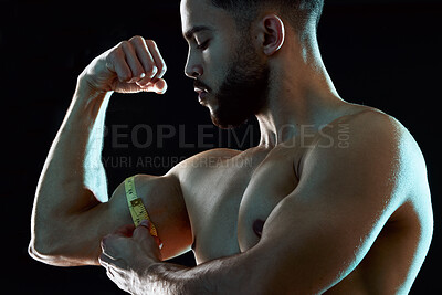 Buy stock photo Healthy, man or athlete measure bicep and flexing in dark studio background for fitness, workout and wellness. Topless, bodybuilder or male person isolated with tape thinking of training and exercise