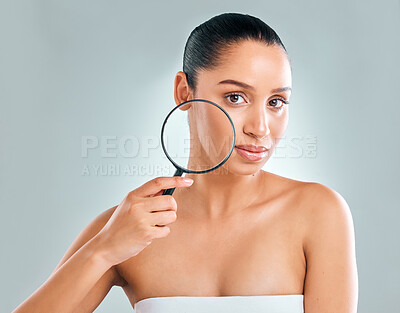 Buy stock photo Skincare, woman and magnifying glass for dermatology inspection of facial cosmetics isolated in studio. Female person or model and beauty with searching lens to check clear skin on gray background