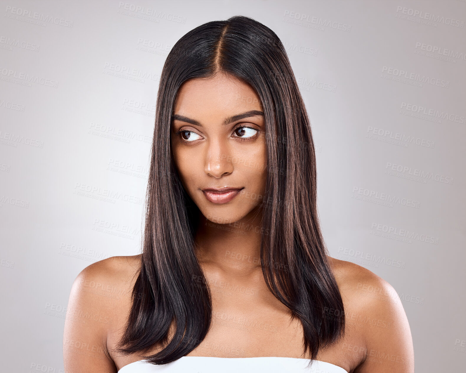 Buy stock photo Shot of a beautiful young woman posing against a grey background