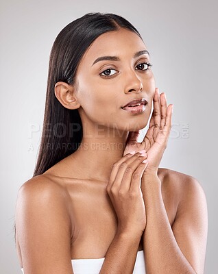 Buy stock photo Shot of a beautiful young woman posing against a grey background