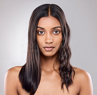 Buy stock photo Shot of a beautiful young woman posing against a grey background