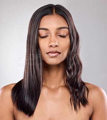 Buy stock photo Shot of a beautiful young woman posing against a grey background