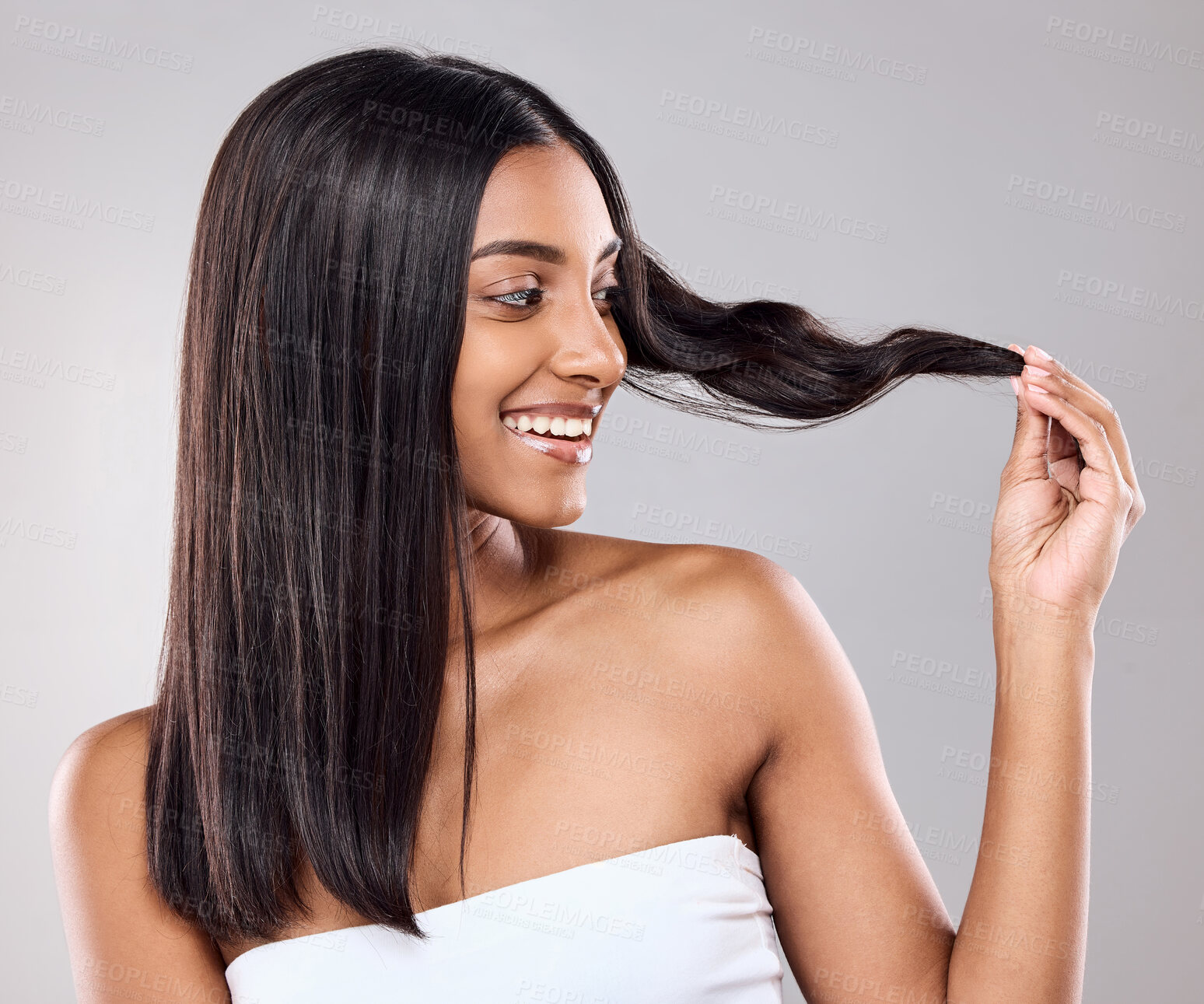 Buy stock photo Shot of a beautiful young woman posing against a grey background