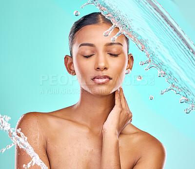 Buy stock photo Shot of an attractive young woman showering against a blue background