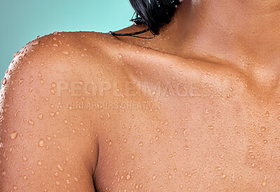 Buy stock photo Water drops, shower and collarbone of woman for skincare with wellness, safety from bacteria and hygiene in studio. Dermatology, liquid and model body with cleaning skin for health by blue background