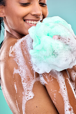 Buy stock photo Shot of an young woman enjoying a soapy shower against a blue background