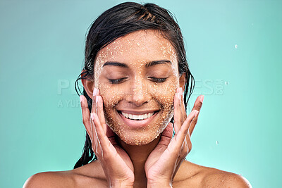 Buy stock photo Woman face, beauty and salt scrub in studio with water drops for skin care, hygiene and dermatology. Model eyes closed thinking of facial exfoliation or makeup removal with texture on blue background