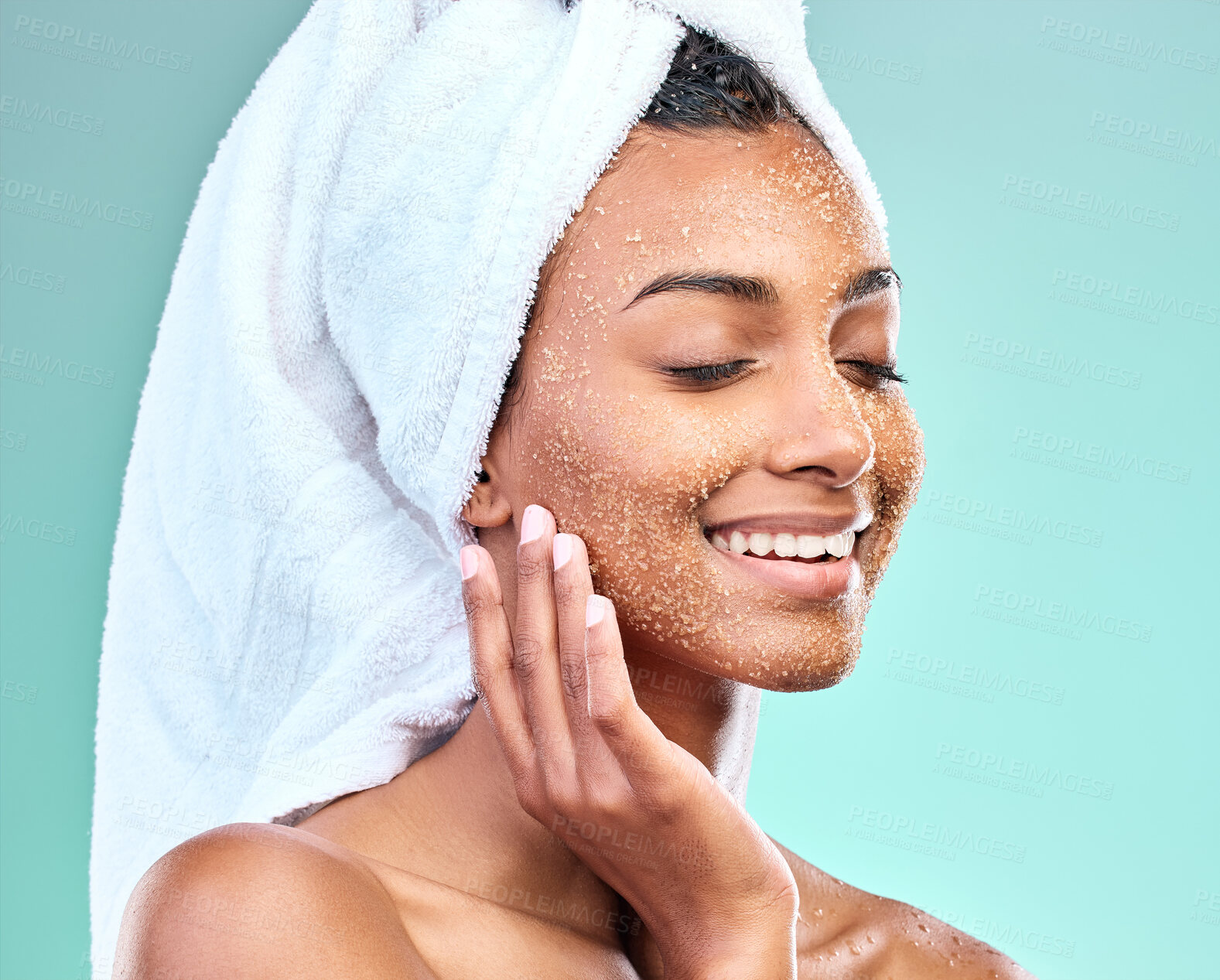 Buy stock photo Woman face, skin care and salt scrub in studio for beauty, exfoliation and wellness or dermatology. Model with sugar texture thinking of cosmetics and makeup removal or facial on blue background