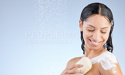 Buy stock photo Studio shot of an attractive young woman taking a shower against a blue background