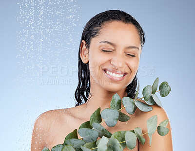 Buy stock photo Studio shot of an attractive young woman taking a shower against a blue background