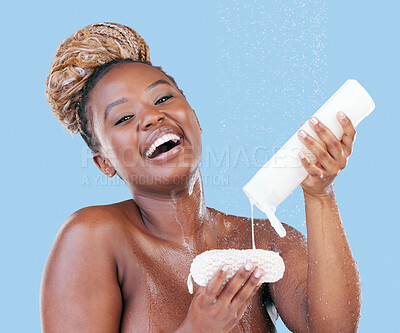 Buy stock photo Studio portrait of an attractive young woman showering against a blue background