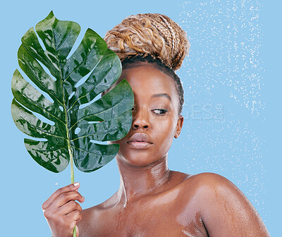 Buy stock photo Studio shot of an attractive young woman showering against a blue background