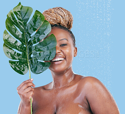 Buy stock photo Studio portrait of an attractive young woman showering against a blue background